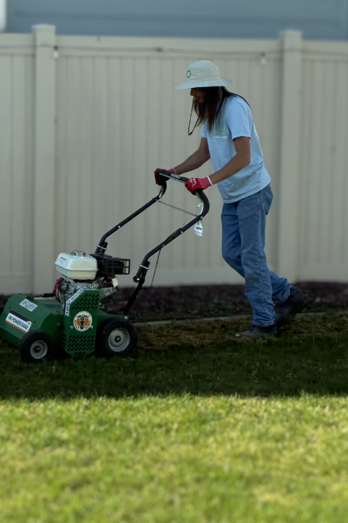 Jordan Embry, owner of Greenwave Lawn & Pool Care LLC, operating a lawn edger